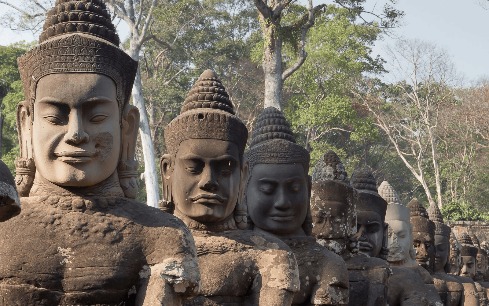 Row of carved heads in Angkor near Siem Reap