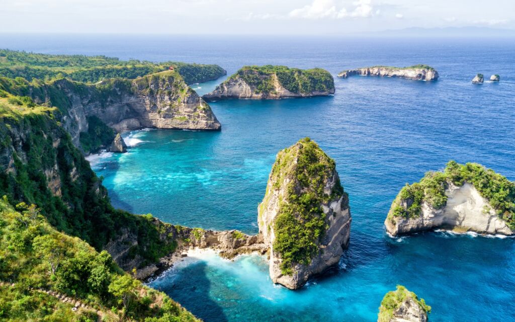 Aerial view of the small island of Nusa Batumategan and Nusa Batupadasan
Island from the Atuh Rija Lima shrine on Nusa Penida Island near Bali, Indonesia.