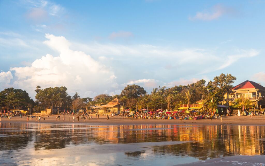 Kuta beach in Seminyak in south Bali at sunset, Indonesia.