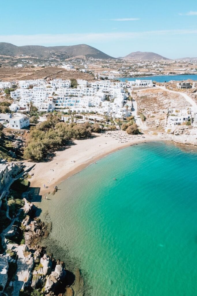 Beautiful Paros beach featuring turquoise waters and charming whitewashed buildings. Perfect for rel.