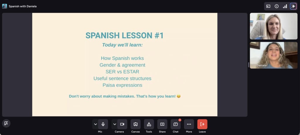 Online Spanish lesson with two students and a presentation slide.